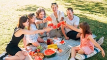 Family having a picnic with fresh fruit Family having a picnic with fresh fruit